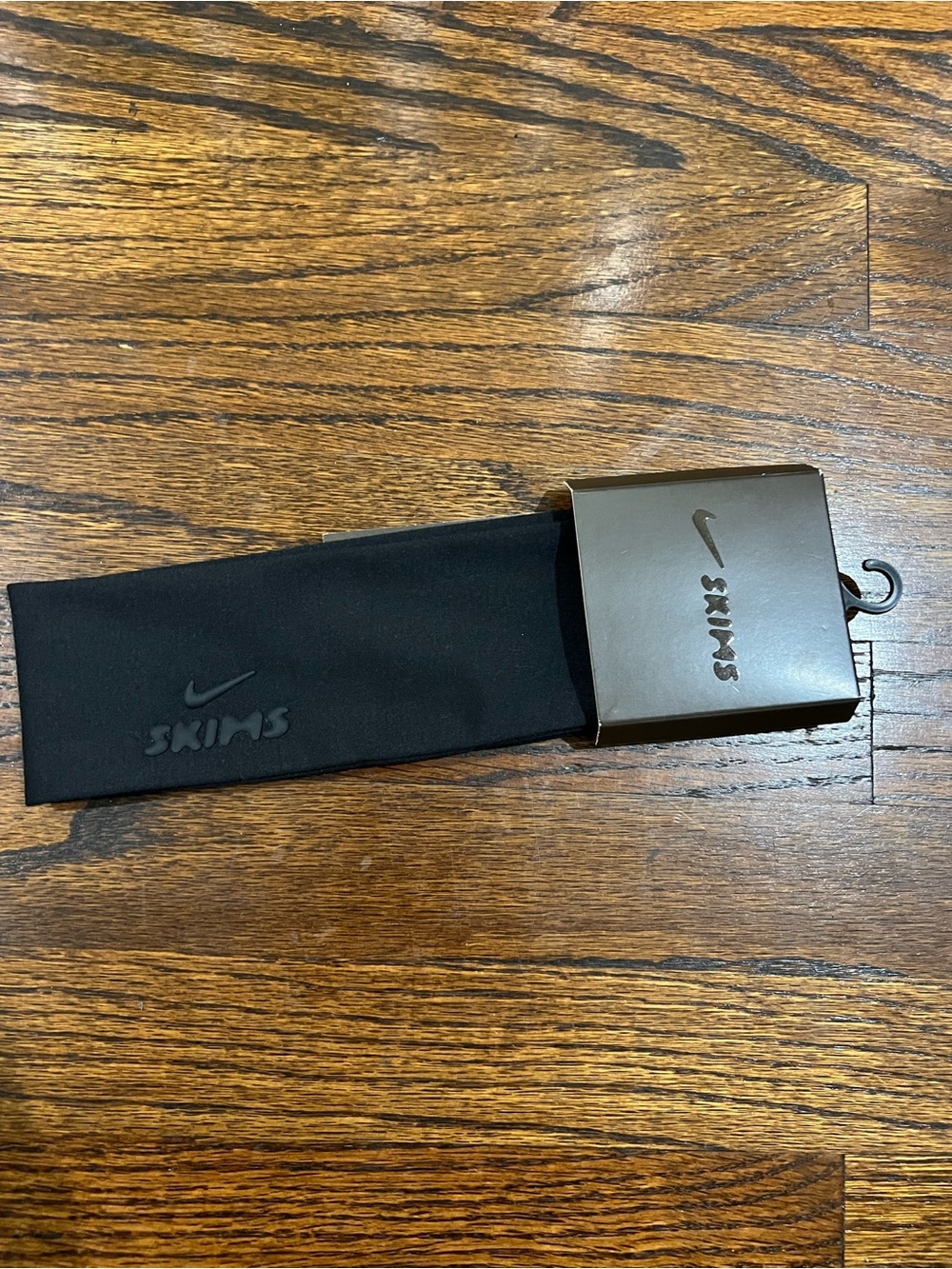 Nike x SKIMS elastic headband featuring a debossed dual-brand logo